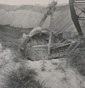 <b>Caption:</b>  Excavating head of bucketwheel excavator.  Photographer: G. Cady   
This is the first bucketwheel excavator, designed by Frank F. Kolbe of United Electric Coal Company.  This was an economical method of moving a great volume of soil and shale and depositing it far enough away to prevent the spoil pile from sliding back into the pit.  This wheel excavator could deposit to a spoil pile 400 ft away.  Bucyrus built the upper portion onto a Marion dragline chassis.  The machine weighed about 1,000 tons and had an output of 1,000 cubic yards of material per hour.  This volume is about 5 times the rate of the Marion dragline model it replaced.<br><b>Credit:</b>  Illinois State Geological Survey<br><b>Date:</b>  1949<br><b>Library No.:</b>  2766 (M-1964)