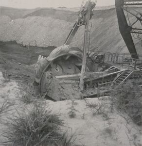 <b>Caption:</b>  Excavating head of bucketwheel excavator.  Photographer: G. Cady   
This is the first bucketwheel excavator, designed by Frank F. Kolbe of United Electric Coal Company.  This was an economical method of moving a great volume of soil and shale and depositing it far enough away to prevent the spoil pile from sliding back into the pit.  This wheel excavator could deposit to a spoil pile 400 ft away.  Bucyrus built the upper portion onto a Marion dragline chassis.  The machine weighed about 1,000 tons and had an output of 1,000 cubic yards of material per hour.  This volume is about 5 times the rate of the Marion dragline model it replaced.<br><b>Credit:</b>  Illinois State Geological Survey<br><b>Date:</b>  1949<br><b>Library No.:</b>  2766 (M-1964)