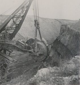 <b>Caption:</b>  Excavating head of first Illinois bucketwheel excavator designed by Frank F. Kolbe of United Electric Coal Company.  This was an economical method of moving a great volume of soil and shale and depositing it far enough away to prevent the spoil pile from sliding back into the pit.  This wheel excavator could deposit to a spoil pile 400 ft away.  Bucyrus built the upper portion onto a Marion dragline chassis.  The machine weighed about 1,000 tons and had an output of 1,000 cubic yards of material per hour.  This volume is about 5 times the rate of the Marion dragline model it replaced.<br><b>Credit:</b>  Illinois State Geological Survey<br><b>Date:</b>  1949<br><b>Library No.:</b>  2765 (M-1963)