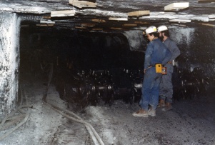<b>Caption:</b>  Curt Lewman (left) and Steve Danner with continuous mining machine. Photo by John Nelson<br><b>Credit:</b>  Illinois State Geological Survey<br><b>Date:</b>  03/24/1981<br><b>Publication:</b>  Mine Notes<br>