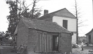 <b>Caption:</b>  Brick house near Danville abandoned on account of danger by room-and-pillar mining of a 6-foot coal at a depth of about 200 feet.<br><b>Credit:</b>  Illinois State Geological Survey<br><b>Date:</b>  Pre-1914<br><b>Library No.:</b>  M-1009
