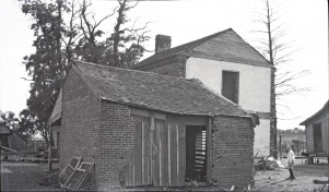 <b>Caption:</b>  Brick house near Danville abandoned on account of danger by room-and-pillar mining of a 6-foot coal at a depth of about 200 feet.<br><b>Credit:</b>  Illinois State Geological Survey<br><b>Date:</b>  Pre-1914<br><b>Library No.:</b>  M-1009