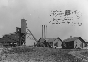 <b>Caption:</b>  Springfield Colliery Company, Sangamon County. The A-frame structure in the center of the photography is the headframe, supporting cables from the engine house on the right. The shaft is below the tower. The structure on the left is the tipple, or loading platform, and the sorting shed is above the tipple.<br><b>Credit:</b>  Illinois State Geological Survey<br><b>Date:</b>  Circa 1910<br>