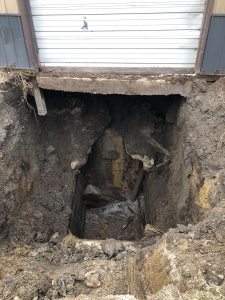 <b>Caption:</b>  The covering of the old shaft (abandoned 1902) has failed, resulting in subsidence below the shed entrance.  Photo courtesy of David Kimmerle, P. E., Division of Abandoned Mined Land Reclamation<br><b>Credit:</b>  Illinois Department of Natural Resources - Office of Mines and Minerals<br><b>Date:</b>  3-2020<br>