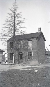 <b>Caption:</b>  Brick house near Danville abandoned on account of danger by room-and-pillar mining of a 6-foot coal at a depth of about 200 feet.<br><b>Credit:</b>  Illinois State Geological Survey<br><b>Date:</b>  Pre-1914<br><b>Library No.:</b>  M-1011