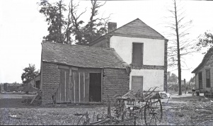 <b>Caption:</b>  Brick house near Danville abandoned on account of danger by room-and-pillar mining of a 6-foot coal at a depth of about 200 feet.<br><b>Credit:</b>  Illinois State Geological Survey<br><b>Date:</b>  Pre-1914<br><b>Library No.:</b>  M-1008