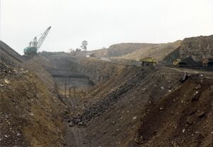 <b>Caption:</b>  Jader Fuel Co. mine, looking south. Springfield Coal on floor of pit below dragline dips north, toward camera. On bench at west (right), Briar Hill Coal is being loaded. Herrin Coal is being uncovered farther to the west, out of the picture.<br><b>Date:</b>  08/27/1986<br>
